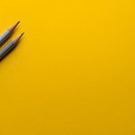 Education Innovation - two gray pencils on yellow surface