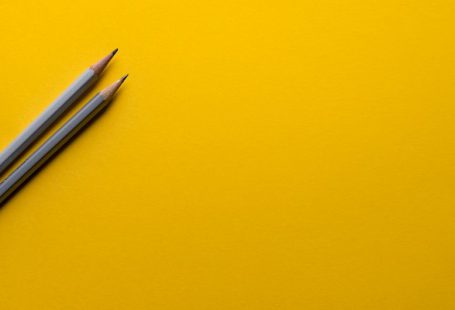 Education Innovation - two gray pencils on yellow surface