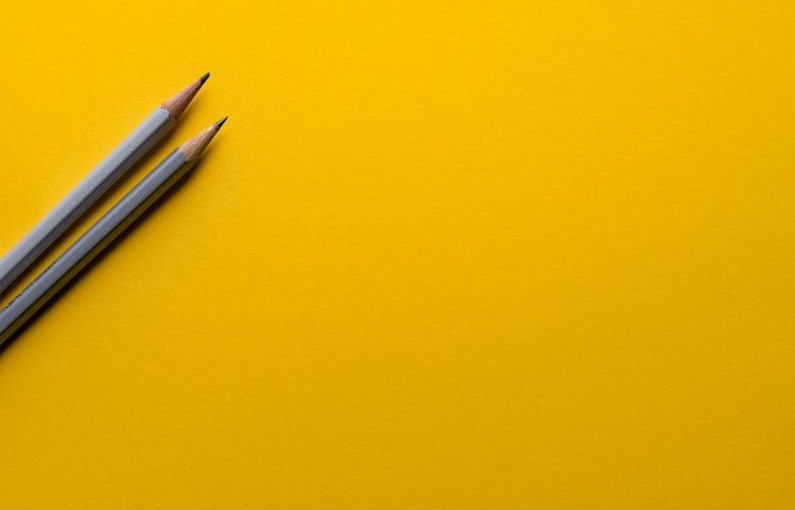 Education Innovation - two gray pencils on yellow surface
