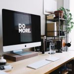 Impact Strategy - silver iMac with keyboard and trackpad inside room