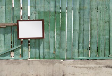 Barriers Wall - a wooden fence with a mirror hanging on it