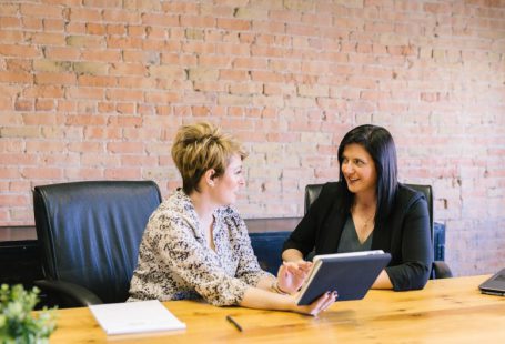Female Leader - two women sitting on leather chairs in front of table