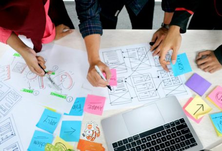 Design Thinking - person writing on white paper