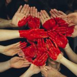 Volunteers Heart - hands formed together with red heart paint