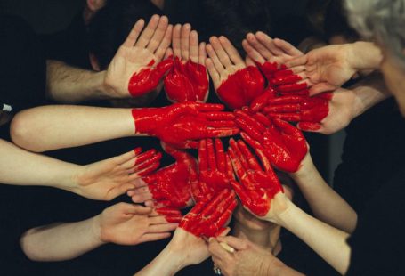 Volunteers Heart - hands formed together with red heart paint