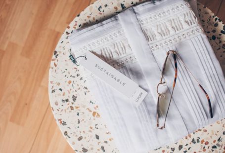 Sustainable Opportunities - silver framed eyeglasses on white and blue floral textile