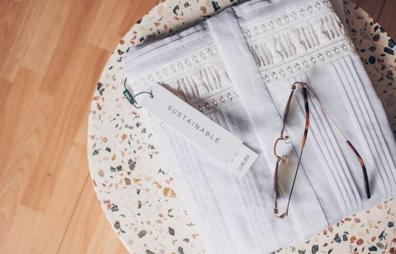 Sustainable Opportunities - silver framed eyeglasses on white and blue floral textile