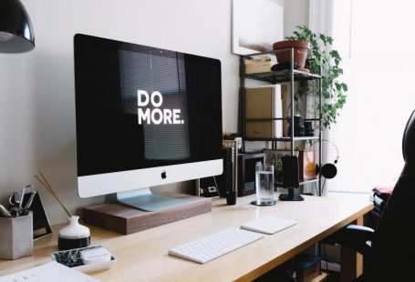 Impact Strategy - silver iMac with keyboard and trackpad inside room