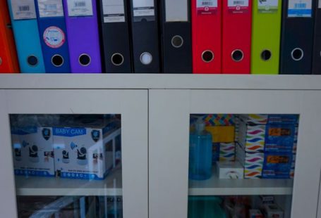 Financial Instruments - a glass door cabinet with a bunch of folders on top of it