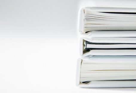 Ethics Book - A stack of thick folders on a white surface