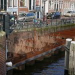 Water Project - a bike is parked on the side of a bridge
