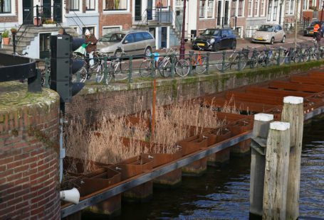 Water Project - a bike is parked on the side of a bridge