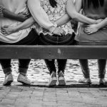 Women Empowerment - grayscale photo of 3 women sitting on wooden bench