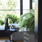 Green Office - black leather rolling armchair near white wooden desk