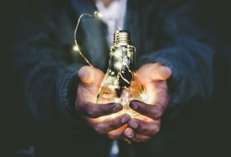 Innovation Eco - man holding incandescent bulb